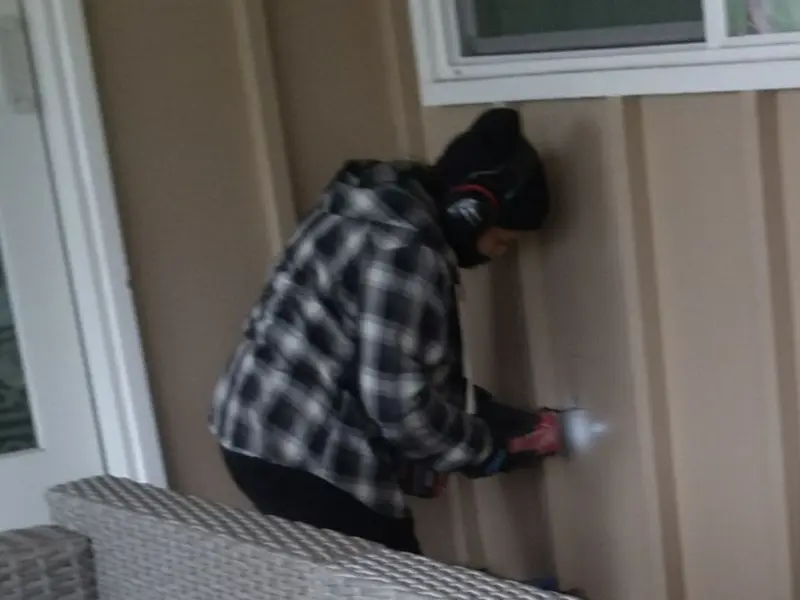 Professional electrician installing an exterior outlet in Iron Mountain
